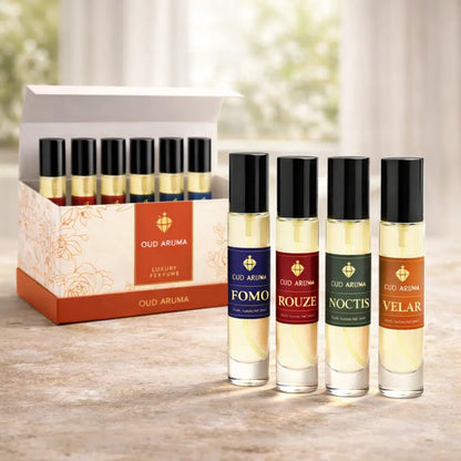 Set of Oud Aruma perfume bottles on a wooden surface with a blurred background